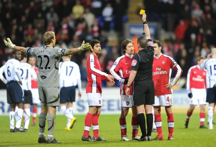 Framed Print : Referee Phil Dowd shows the yellow card to Arsenals Tomas Rosicky
