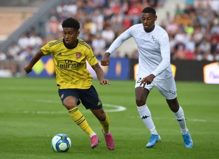 Framed Print : Reiss Nelson Faces Off Against Jeff Reine-Adelaide in Angers vs Arsenal Pre-Season Clash