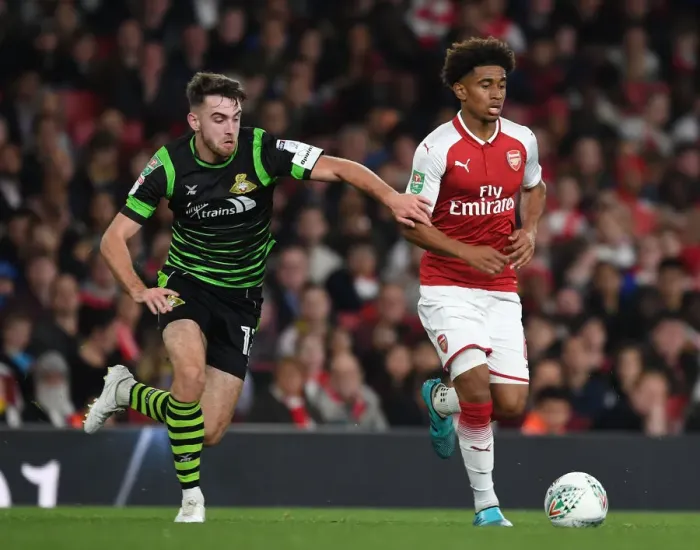 Framed Print : Reiss Nelson Outmaneuvers Ben Whiteman: Arsenal vs Doncaster Rovers, Carabao Cup 2017-18