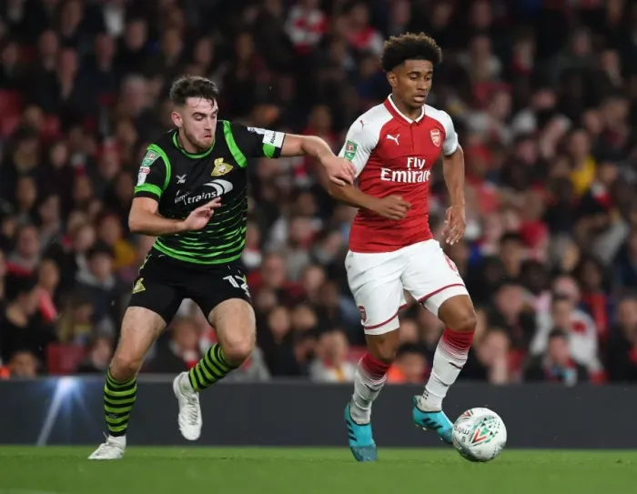 Framed Print : Reiss Nelson Outmaneuvers Ben Whiteman in Arsenal's Carabao Cup Victory Framed Print : Reiss Nelson Outmaneuvers Ben Whiteman in Arsenal's Carabao Cup Victory