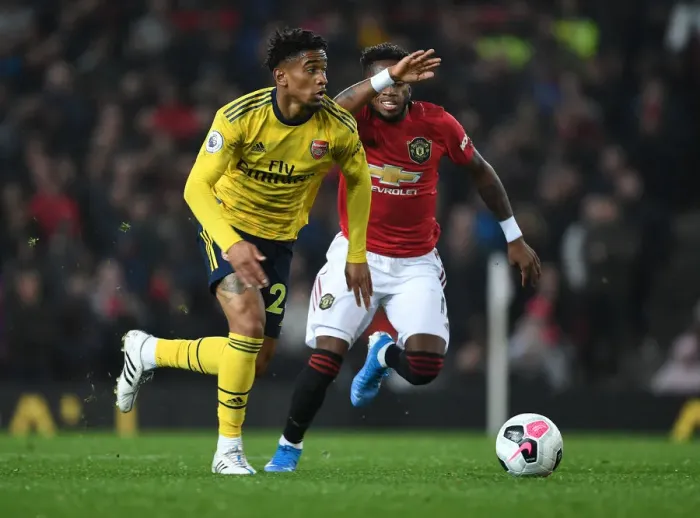 Framed Print : Reiss Nelson Outsmarts Fred: A Crucial Turning Point in the Manchester United vs. Arsenal Battle, Premier League 2019-20