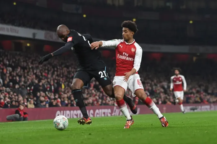 Framed Print : Reiss Nelson vs Angelo Ogbonna: Intense Battle in Arsenal's Carabao Cup Quarterfinal Against West Ham