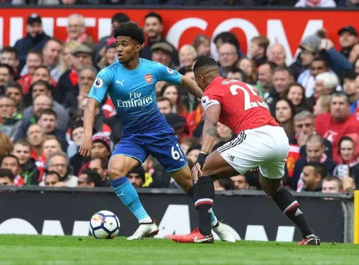 Framed Print : Reiss Nelson vs. Antonio Valencia: A Premier League Showdown at Old Trafford