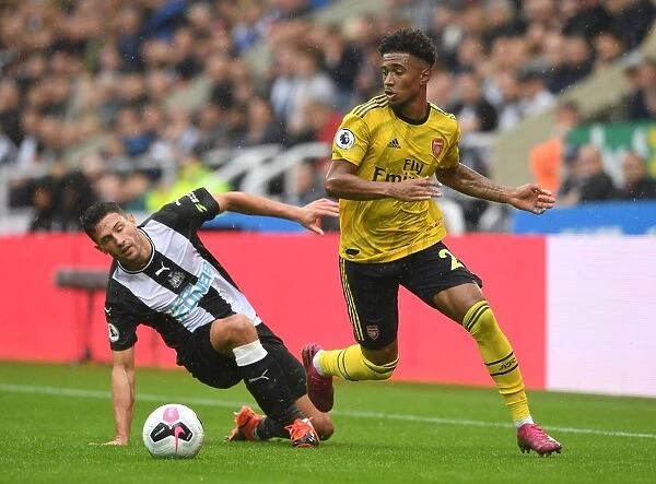 Reiss Nelson vs Fabian Schar: Intense Battle at St. James Park - Newcastle United vs Arsenal FC, Premier League 2019-20