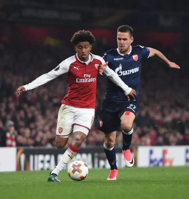 Framed Print : Reiss Nelson vs Marko Gobeljic: A Battle in the Europa League - Arsenal FC vs Crvena Zvezda