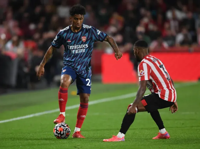 Framed Print : Reiss Nelson vs Rico Henry: Battle at Brentford Community Stadium - Arsenal vs Brentford, Premier League 2021-22