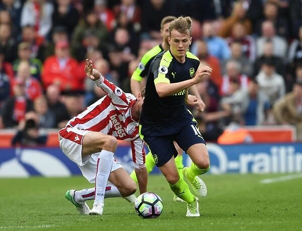 Rob Holding Outmuscles Peter Crouch: A Battle in the Premier League Clash Between Stoke City and Arsenal