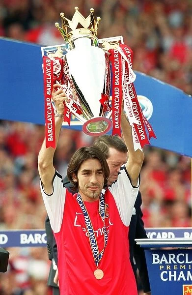 Robert Pires lifts the F.A.Barclaycard Premiership Trophy