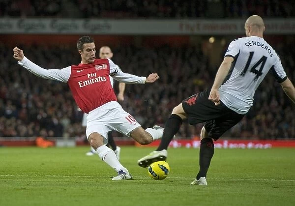 Robin van Persie of Arsenal breaks shoots Philippe Senderos of Fulham during the Barclays Premier League match between Arsenal and Fulham at Emirates Stadium on November 26, 2011 in London, England. Credit; Arsenal