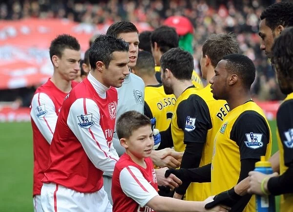 Robin van Persie (Arsenal) shakes hands with Junior Hoilett (Rovers) before the match