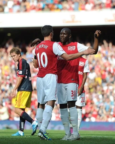 Robin van Persie celebrates scoring Arsenals goal with Benik Afobe