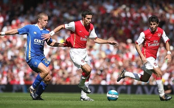 Robin van Persie and Cesc Fabregas (Arsenal) iSean Davis (Portsmouth)