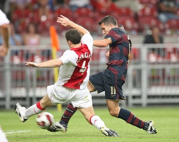 Robin van Persie shoots past Thomas Vermaelen to score the Arsenal goal