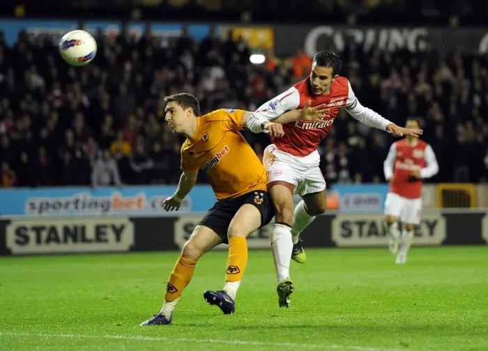 Framed Print : Robin van Persie vs. Stephen Ward: Intense Heading Duel in Arsenal's Premier League Clash with Wolverhampton Wanderers