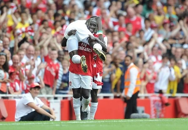 Sagna and Eboue: Arsenal's Unstoppable Duo Celebrate Goal in Emirates Cup Victory
