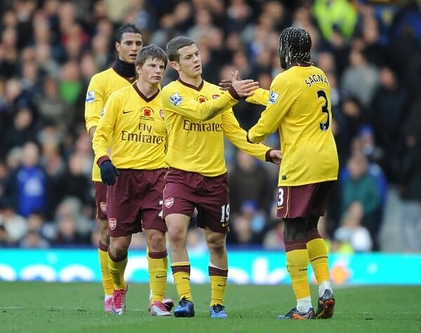 Sagna's Stunner: Arshavin, Chamakh, and Wilshere Celebrate Arsenal's Winning Goal vs. Everton, 2010