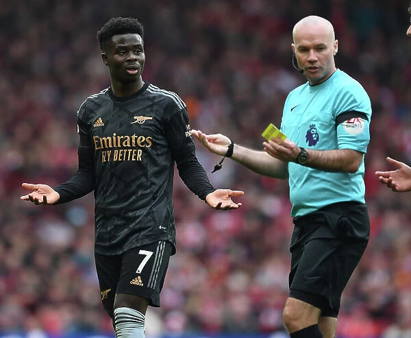 Saka and Referee Tierney in Intense Liverpool vs. Arsenal Premier League Clash