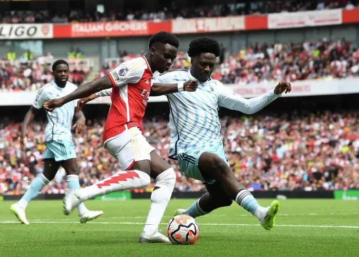 Framed Print : Saka vs. Aina: Intense Battle in Arsenal's 2023-24 Premier League Clash