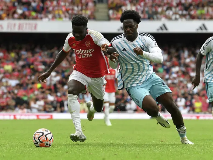 Framed Print : Saka vs. Aina: A Premier League Battle at Emirates Stadium