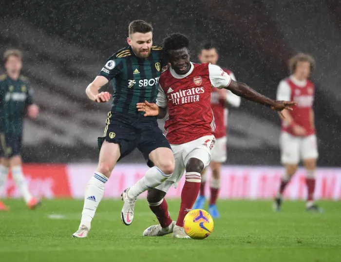 Framed Print : Saka vs Dallas: A Premier League Battle of Young Talents - Arsenal's Rising Star vs Leeds Midfield Mastermind