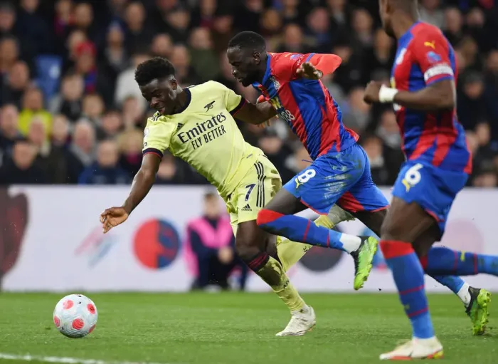 Framed Print : Saka vs. Kouyate: Intense Clash at Selhurst Park, Premier League 2021-22