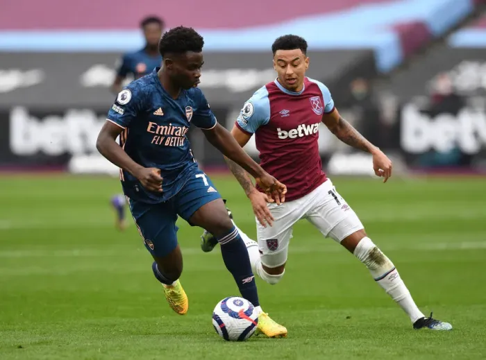 Framed Print : Saka vs Lingard: Intense Battle in West Ham United vs Arsenal Premier League Clash