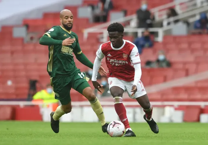 Framed Print : Saka vs McGoldrick: Intense Face-Off in Arsenal's Battle Against Sheffield United Framed Print : Saka vs McGoldrick: Intense Face-Off in Arsenal's Battle Against Sheffield United