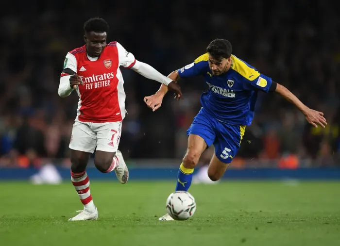 Framed Print : Saka vs. Nightingale: Arsenal's Star Forward Meets Wimbledon's Defender in Carabao Cup Battle