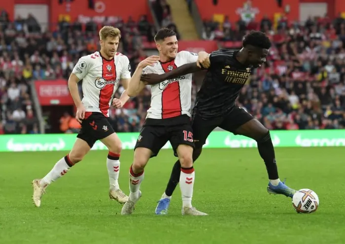 Framed Print : Saka vs Perraud: Intense Battle in Southampton v Arsenal Premier League Clash