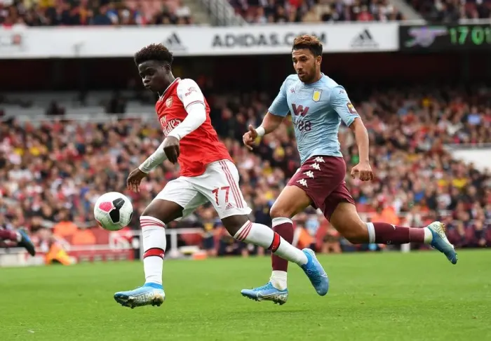 Framed Print : Saka vs. Trezeguet: A Premier League Showdown - Intense Face-Off Between Arsenal's Young Gun and Aston Villa's Midfielder Framed Print : Saka vs. Trezeguet: A Premier League Showdown - Intense Face-Off Between Arsenal's Young Gun and Aston Villa's Midfielder