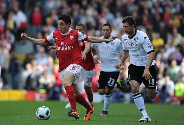 Samir Nasri (Arsenal) Aaron Hughes (Fulham). Fulham 2: 2 Arsenal, Barclays Premier League