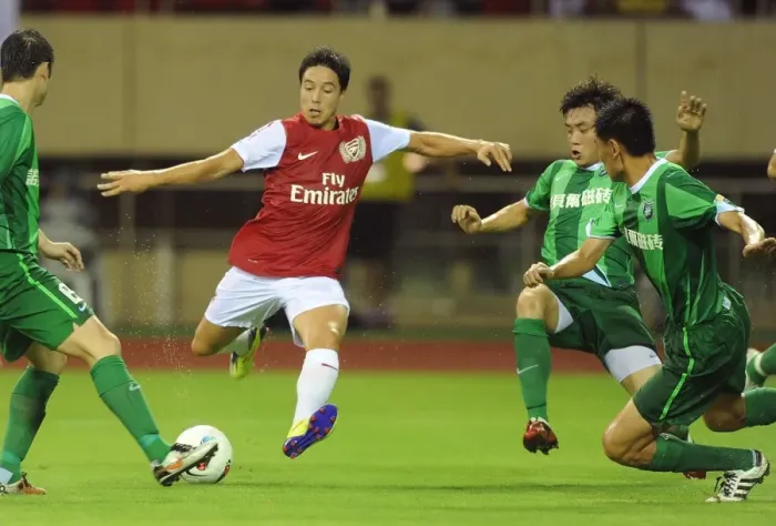 Framed Print : Samir Nasri Clashes with Hangzhou Greentown's Li Yan and Yang Zi during Arsenal's Pre-Season Match in China Framed Print : Samir Nasri Clashes with Hangzhou Greentown's Li Yan and Yang Zi during Arsenal's Pre-Season Match in China
