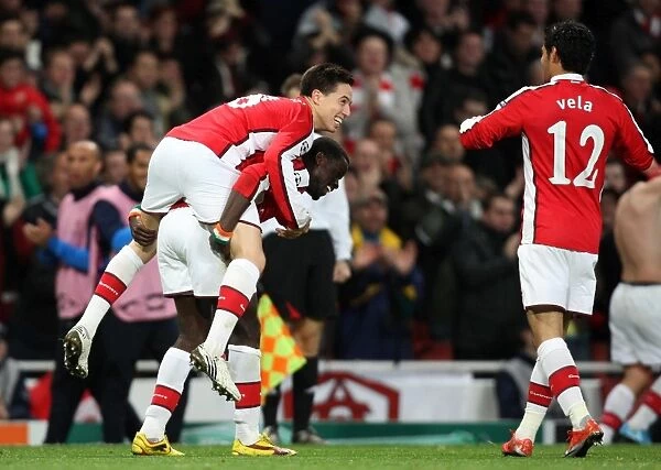 Samir Nasri, Emmanuel Eboue, and Carlos Vela: Celebrating Arsenal's First Goal in a 2-0 Win Against Standard Liege in the UEFA Champions League (2009)