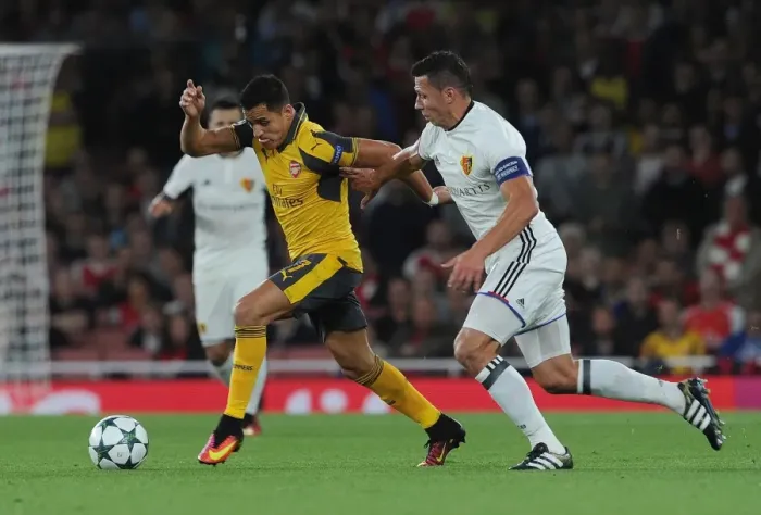 Framed Print : Sanchez vs. Suchy: A Champions League Showdown - Intense Face-Off Between Arsenal's Sanchez and Basel's Defender Framed Print : Sanchez vs. Suchy: A Champions League Showdown - Intense Face-Off Between Arsenal's Sanchez and Basel's Defender