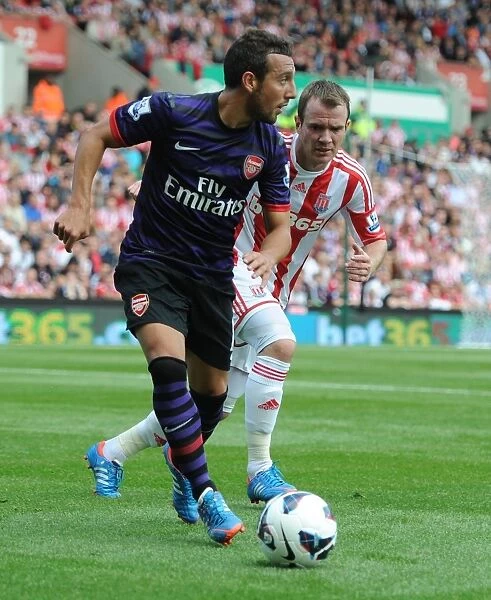 Santi Cazorla Outmaneuvers Glenn Whelan: A Moment from the Stoke City vs. Arsenal Premier League Clash (2012-13)