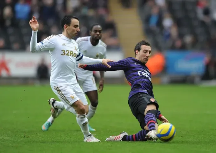 Framed Print : Santi Cazorla Outmaneuvers Leon Britton: Swansea v Arsenal - FA Cup Third Round