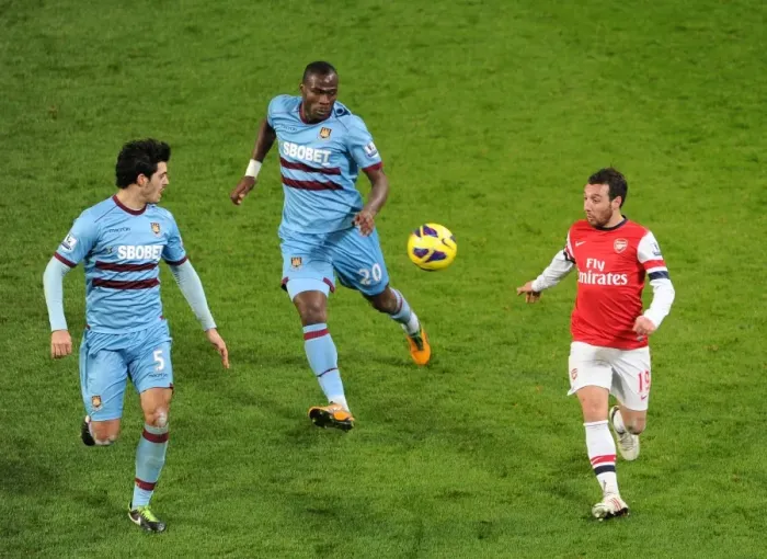 Framed Print : Santi Cazorla vs. Guy Demel and James Tomkins: Intense Battle at Arsenal v West Ham United (2013)