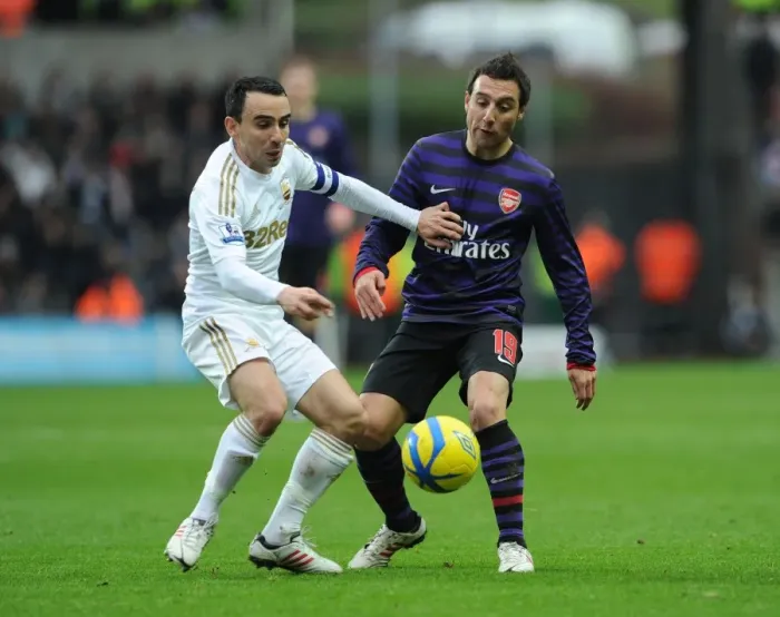 Framed Print : Santi Cazorla vs. Leon Britton: Intense Battle in Swansea v Arsenal FA Cup Clash Framed Print : Santi Cazorla vs. Leon Britton: Intense Battle in Swansea v Arsenal FA Cup Clash