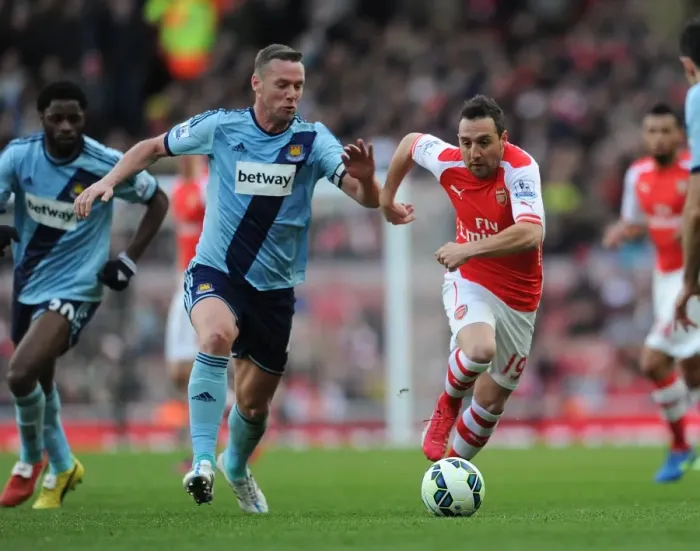 Framed Print : Santi Cazorla's Agile Moves: Outmaneuvering Kevin Nolan in Arsenal's Premier League Victory