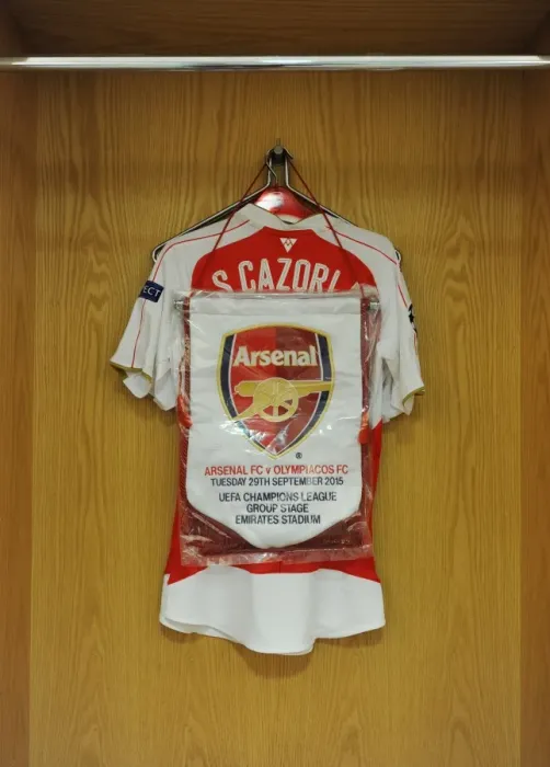 Framed Print : Santi Cazorla's Arsenal FC Changing Room: Shirt and Match Pennant (Arsenal vs. Olympiacos, UEFA Champions League, 2015 / 16) Framed Print : Santi Cazorla's Arsenal FC Changing Room: Shirt and Match Pennant (Arsenal vs. Olympiacos, UEFA Champions League, 2015 / 16)
