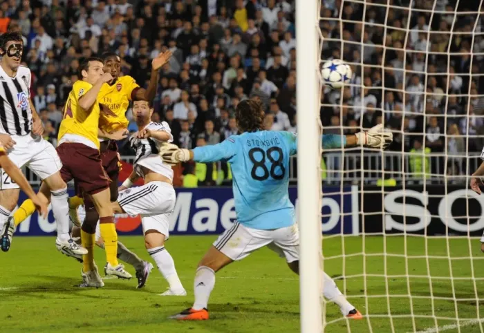 Framed Print : Sebastien Squillaci heads past Partizan goalkeeper Vladimir Stojkovic to score the 3rd Arsenal goal