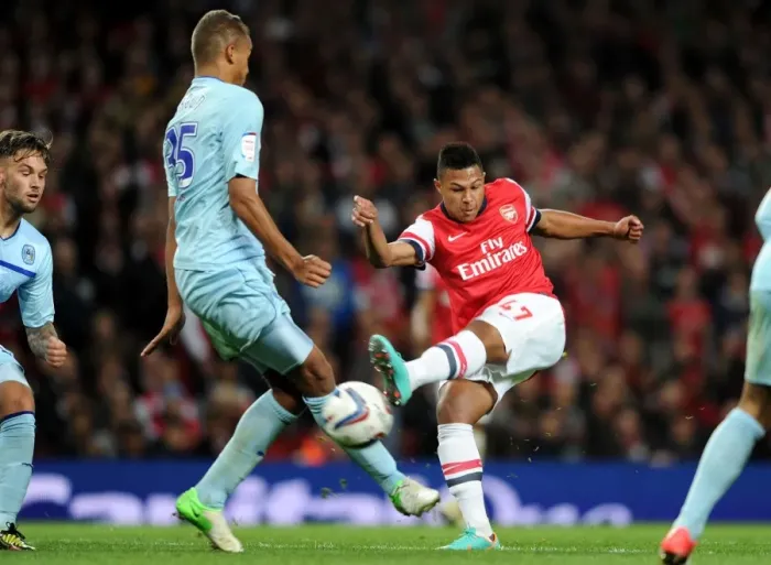 Framed Print : Serge Gnabry vs Reece Brown: Intense Moment at Arsenal v Coventry City - Capital One Cup 2012-13