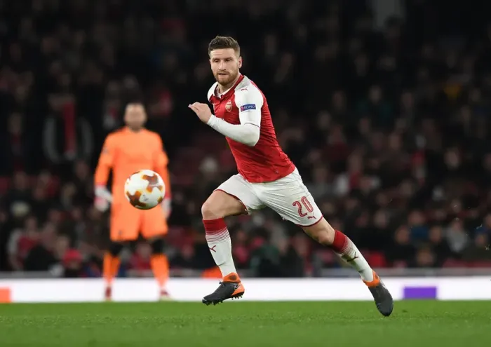 Framed Print : Shkodran Mustafi Focuses in Arsenal's Europa League Battle against AC Milan
