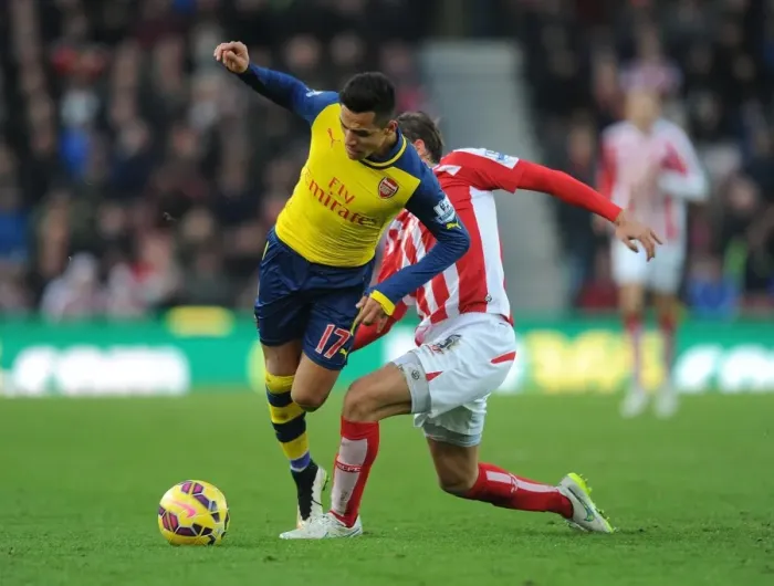 Framed Print : Sneaky Moves: Alexis Sanchez Outwits Marc Muniesa in the Stoke City vs. Arsenal Premier League Clash (2014-15)