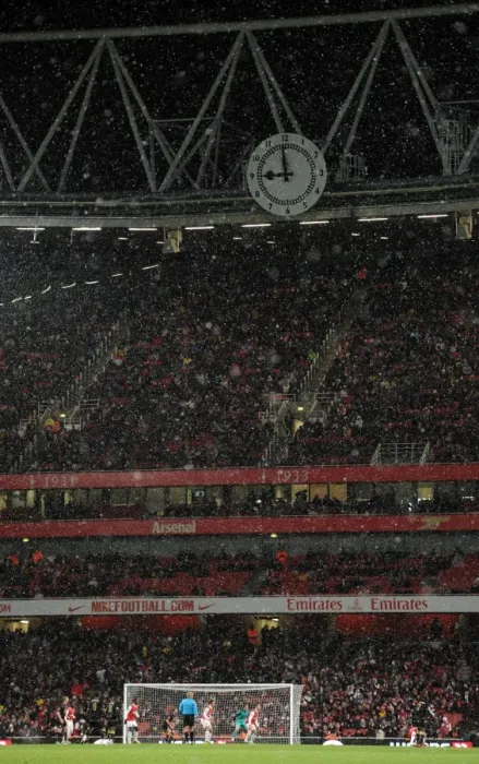 Framed Print : Snow falls across the Clock End during the match. Arsenal 2: 0 Wigan Athletic