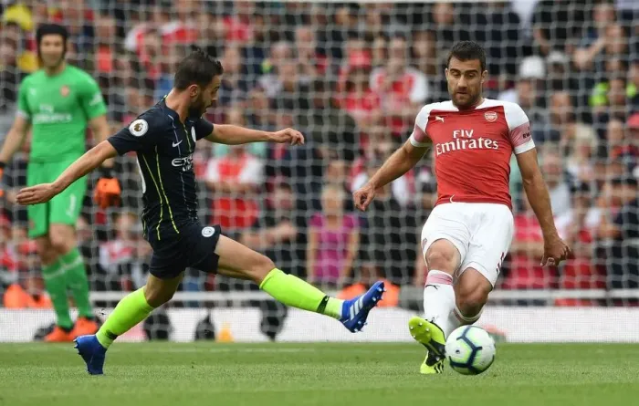 Framed Print : Sokratis under Pressure: Arsenal's Battle Against Manchester City
