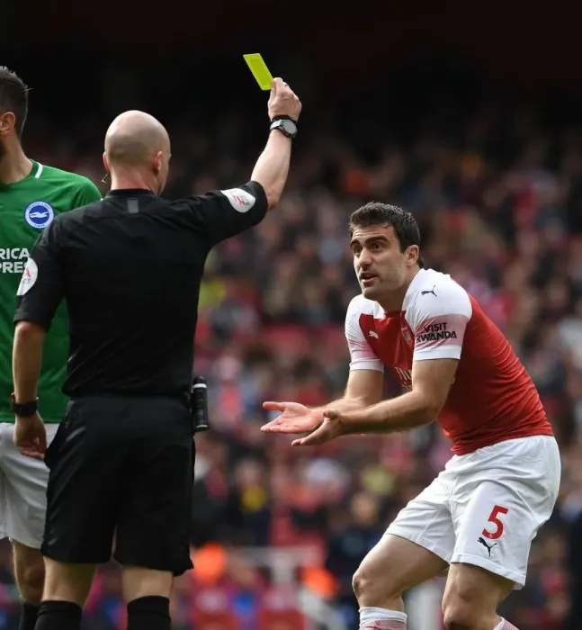 Framed Print : Sokratis Shown Yellow Card by Referee Taylor in Arsenal vs. Brighton Match