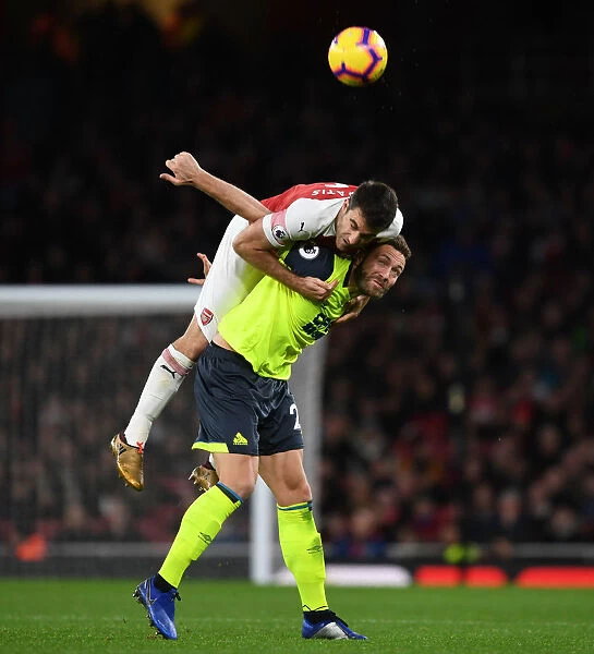 Sokratis vs. Depoitre: A Battle of Strength in Arsenal's Victory over Huddersfield (2018-19)