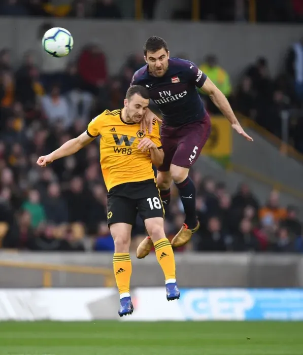 Framed Print : Sokratis vs. Diogo Jota: Intense Heading Battle at Wolverhampton Wanderers vs. Arsenal FC, Premier League 2018-19