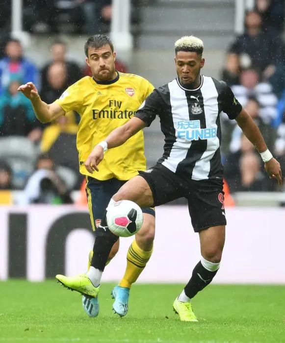 Framed Print : Sokratis vs Joelinton: Intense Battle in Newcastle United vs Arsenal FC Premier League Clash